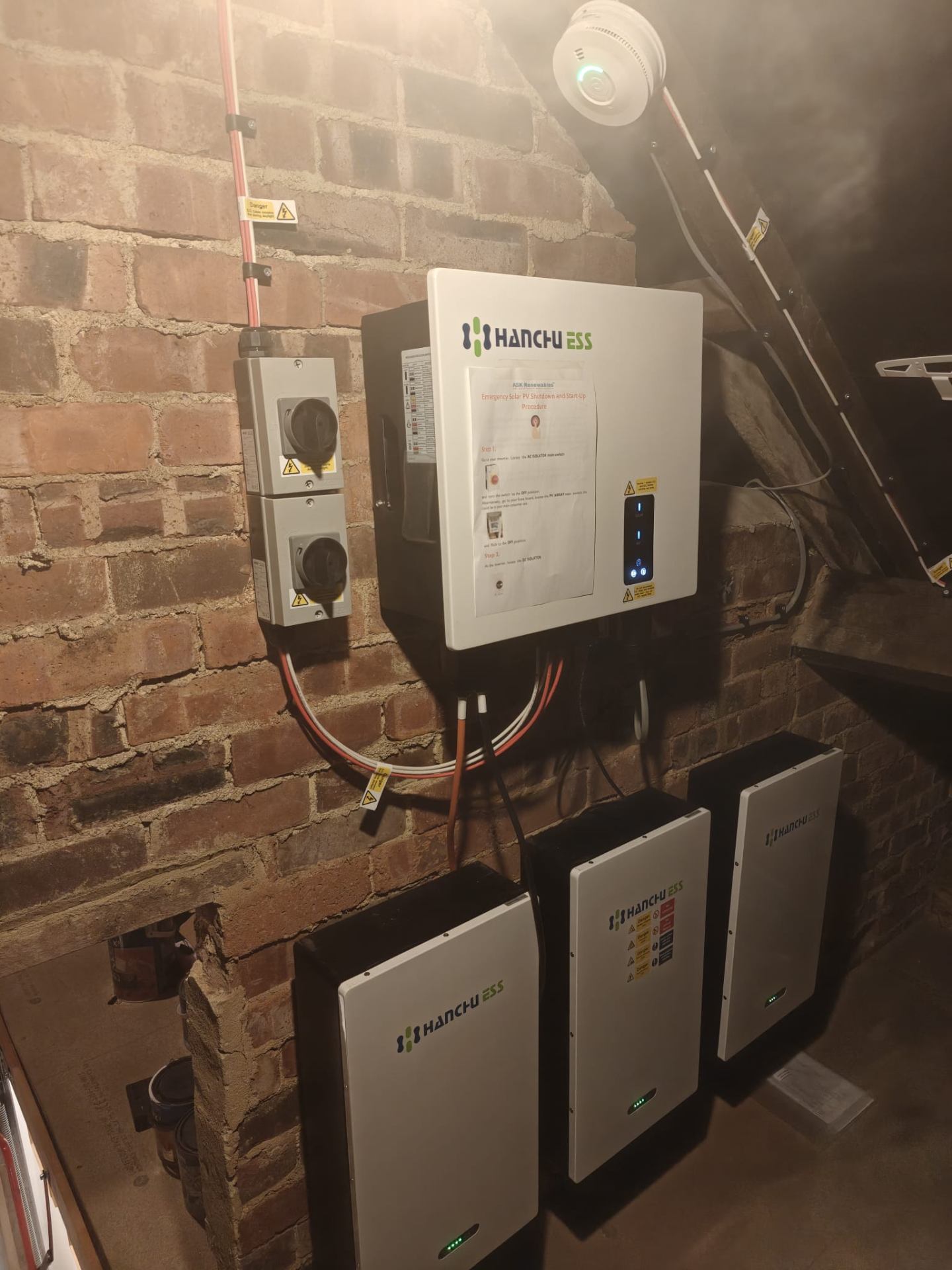Hanchu ESS inverter and three battery units in a cellar