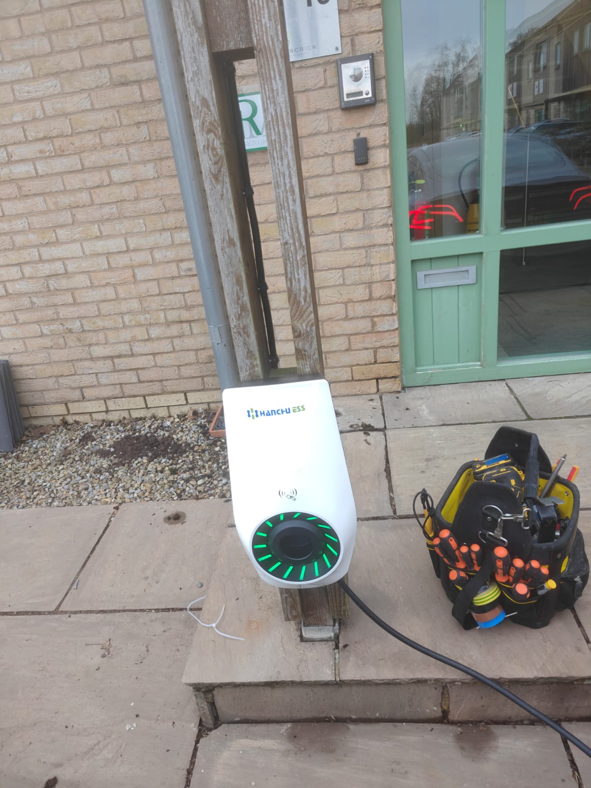 Hanchu ESS EV charger mounted by a front door